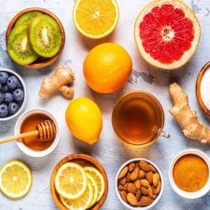 A table topped with bowls of fruit and tea.