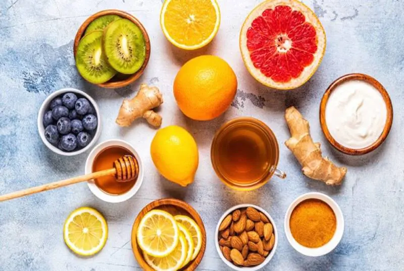 A table topped with bowls of fruit and tea.