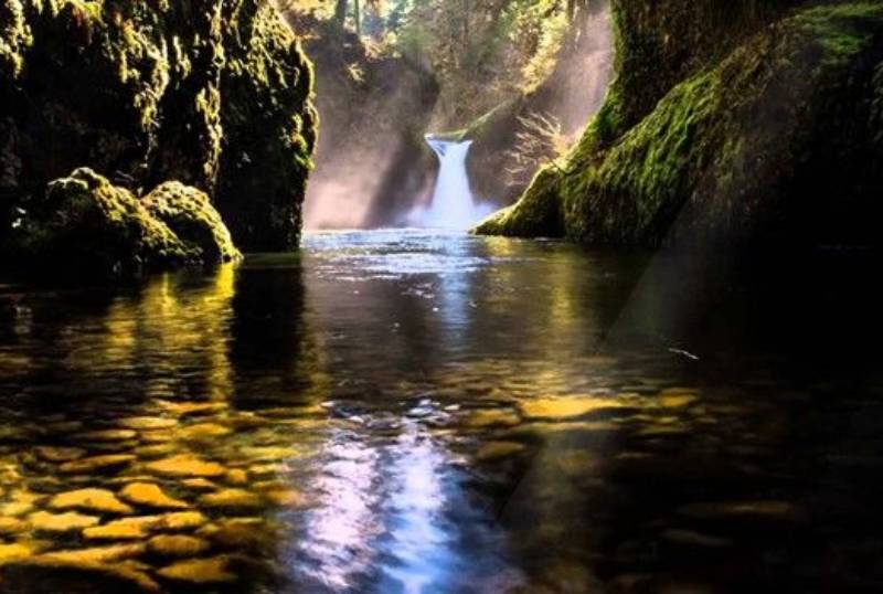 A waterfall in the middle of a river.