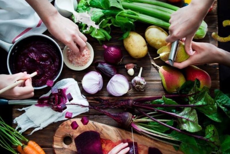 A table with vegetables and other foods on it